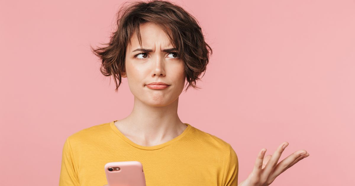 Annoyed woman with cell - stop cold pitching in DM